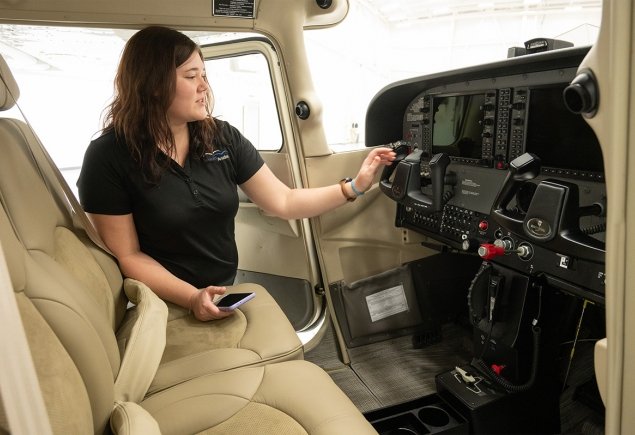 Girl showing plane panel