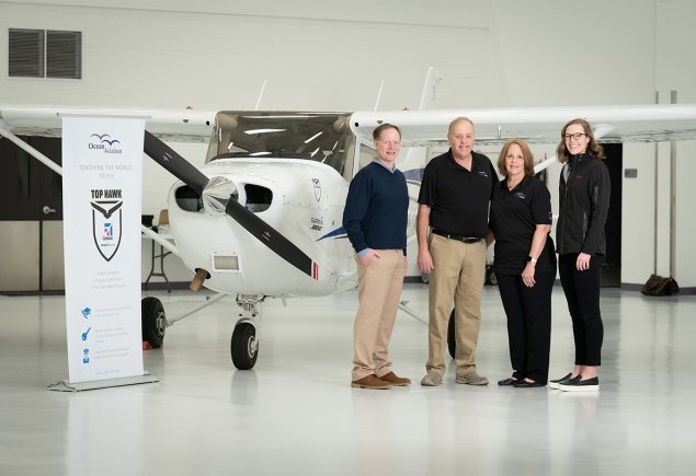 OA owners joined by two others stand in front of plane