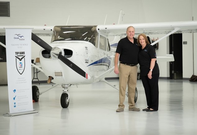 Owners beside a plane